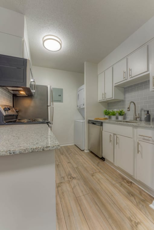 a kitchen with white cabinets and stainless steel appliances at Brightwaters Apartments, Little Rock, 72202
