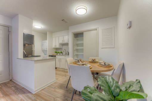 a dining room and kitchen with a table and chairs at Brightwaters Apartments, Little Rock, AR,72202