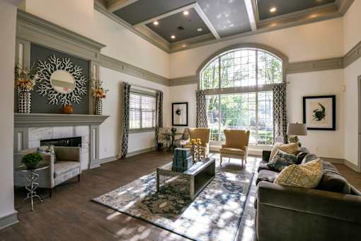 A living room with a fireplace and a large mirror on the wall.