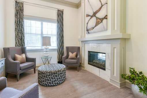A living room with a fireplace and a painting on the wall.