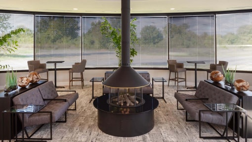 a living room with a fireplace in the middle at Esplanade District Apartments, Little Rock