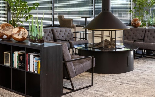 a living room with couches and chairs and a table with a lamp at Esplanade District Apartments, Little Rock, 72114