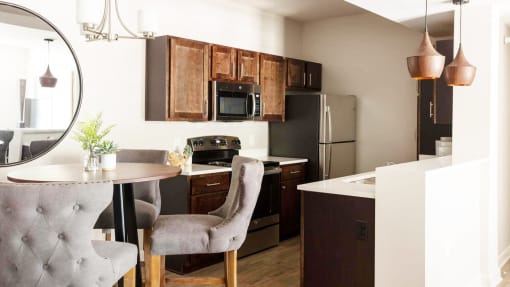 a kitchen and dining room with a table and chairs at Esplanade District Apartments, Arkansas