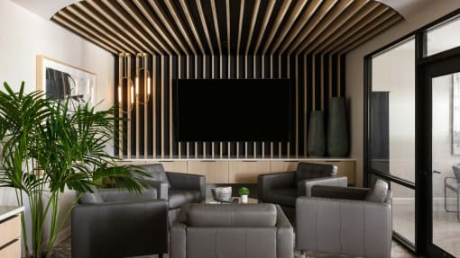a living room with couches and a tv on the wall at Esplanade District Apartments, Little Rock, Arkansas