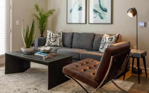 a living room with a couch and a coffee table at Esplanade District Apartments, Little Rock, Arkansas