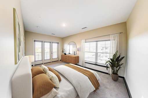 A bedroom with a large bed and a window overlooking a balcony at Harbor Side at Conwood Flats Apartments in Uptown Memphis, TN