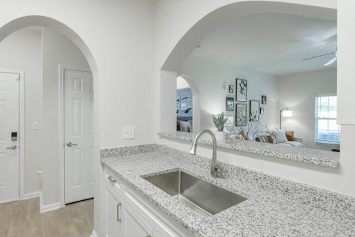 A kitchen with a sink and a countertop. at Henley at Mirror Lake, Villa Rica, 30180