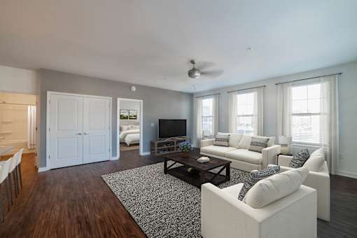 A living room with a white couch and a television.