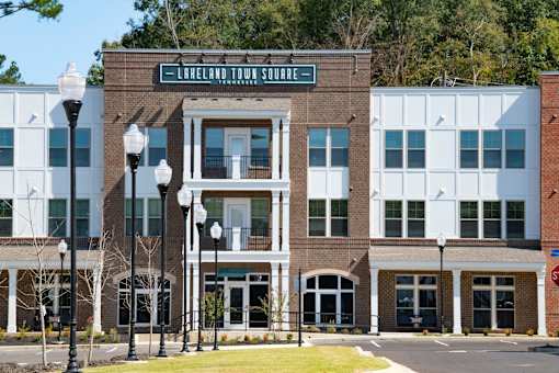 A street view of a building with the sign "Lareland Town Square" on it.