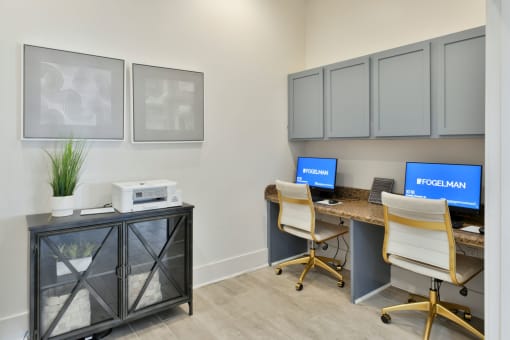 an office with two desks and two chairs and a desk with a computer on it