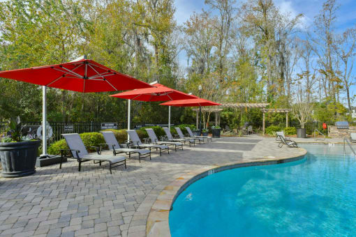 a swimming pool with umbrellas and chairs next to it at Legends at Chatham, Georgia, 31405