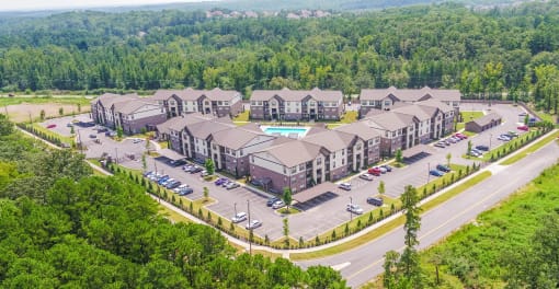 an aerial view of a building surrounded by trees