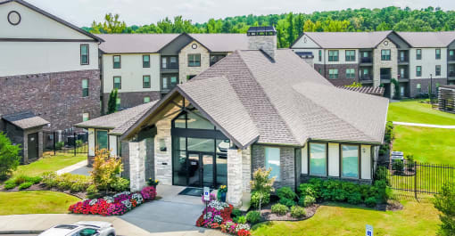 an aerial view of a house with an apartment building in the background