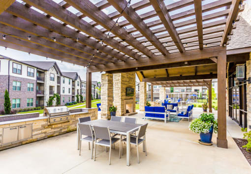 a patio with a table and chairs and a pergola