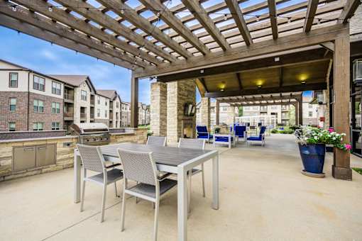 Patio with a Table and Chairs at McKenzie Park Apartments, Little Rock, AR, 72223