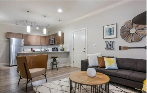a living room and kitchen with a couch and a table