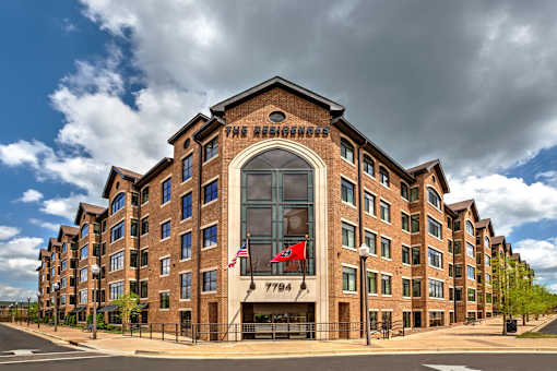 The Residence hotel with a flag on the building.