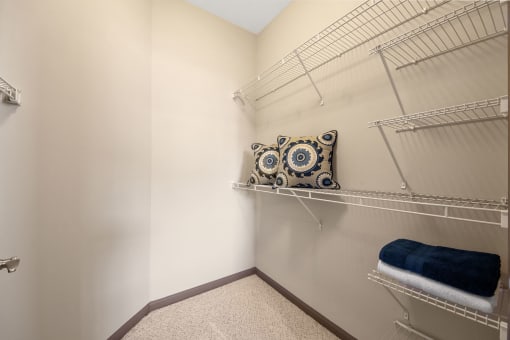 plenty of closet space in the closet with shelves and a pillow at The Ridge at Chenal Valley, Little Rock