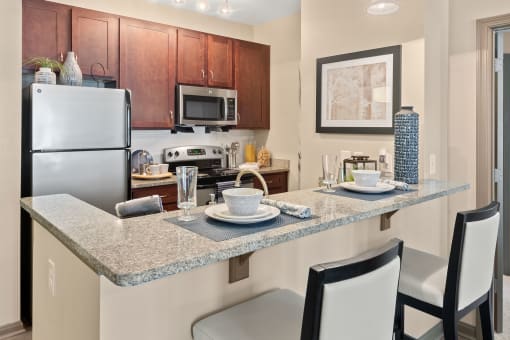a kitchen with granite counter tops and stainless steel appliances at The Ridge at Chenal Valley, Little Rock, AR 72223