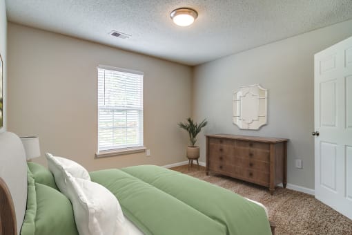 a bedroom with a bed and a dresser and a window  at Serene at Creekstone, Georgia, 30601