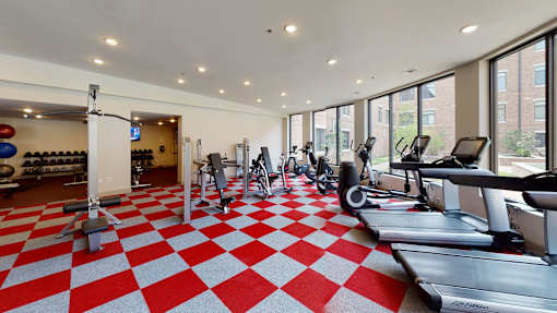 A gym with a red and white checkered floor.