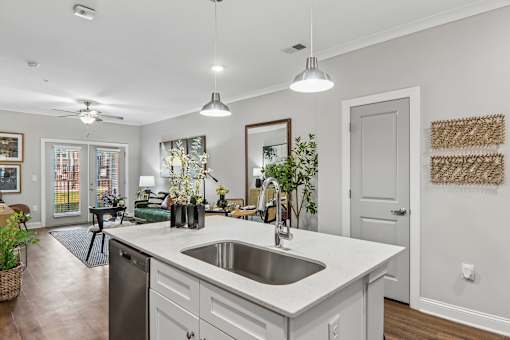A modern kitchen with a large island and a stainless steel dishwasher.