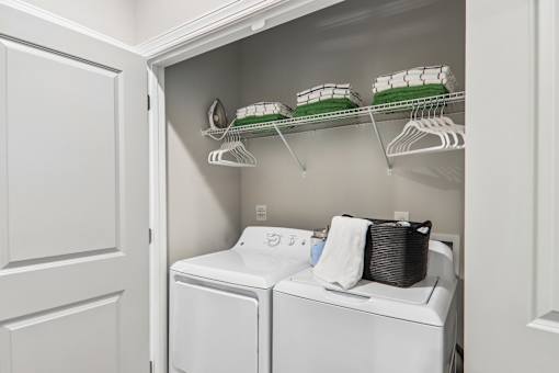 A small laundry room with a washer and dryer.