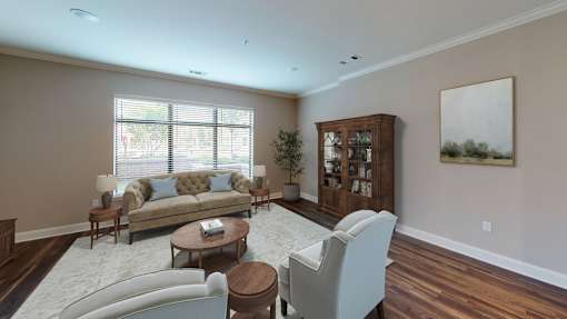 A living room with a couch, chair, and a cabinet.