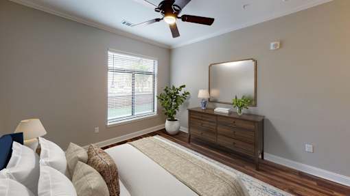 A living room with a white couch and a wooden dresser.
