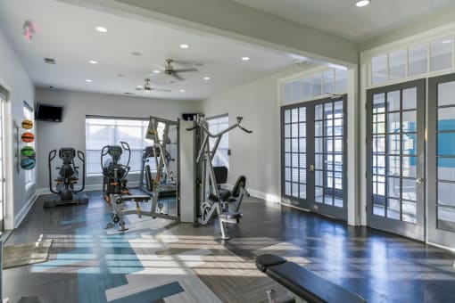 a gym with weights and cardio equipment in a home at The Shallowford, Chattanooga