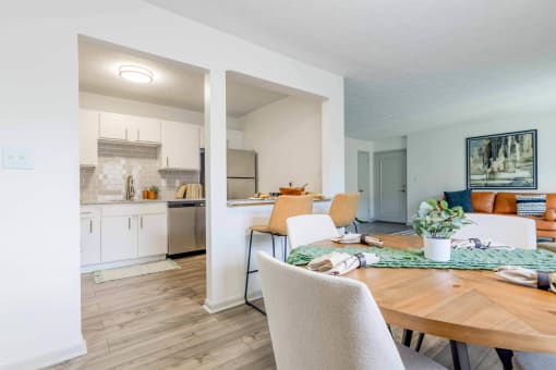 a dining room and kitchen with a table and chairs at The Waters at Chenal, Little Rock, AR 72211