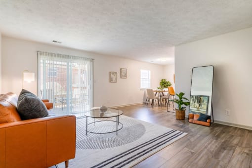 a living room with a couch and a mirror at The Waters at Chenal, Little Rock, 72211