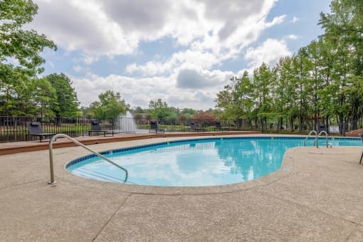 a swimming pool with trees and a fence around it at The Waters at Chenal, Little Rock, 72211