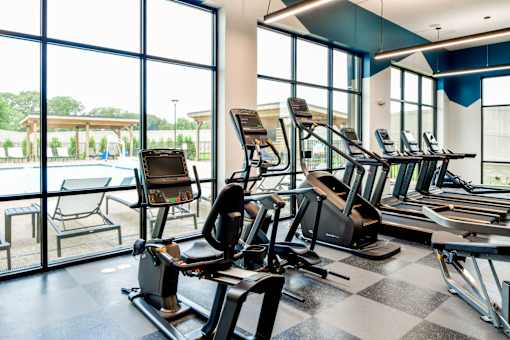 A gym with treadmills and exercise equipment.
