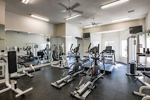 Trailside at Greenline spacious gym with a variety of equipment including treadmills, weights, and exercise machines.
