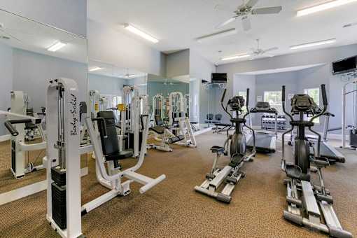 Gym with a variety of equipment including treadmills, stationary bikes, and weight machines at Trailside at Greenline, Cordova