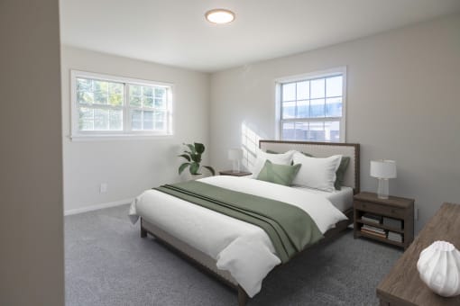 a bedroom with a bed and two windows