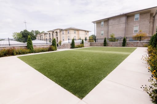a green lawn in front of a building at The Villa at River Pointe, Arkansas, 72213
