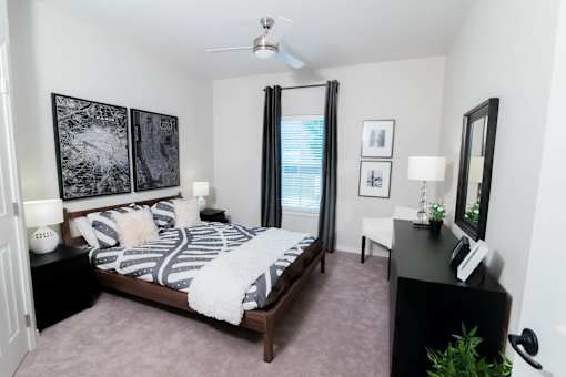 a bedroom with a bed and a ceiling fan