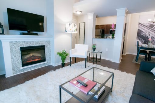 a living room with a fireplace and a television at The Villa at River Pointe, Arkansas, 72213