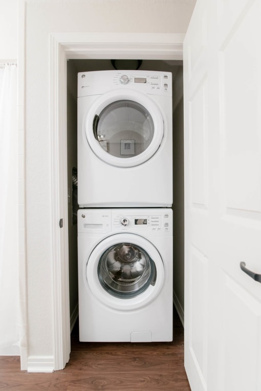a white washer and dryer in a small laundry room at The Villa at River Pointe, Maumelle, 72213