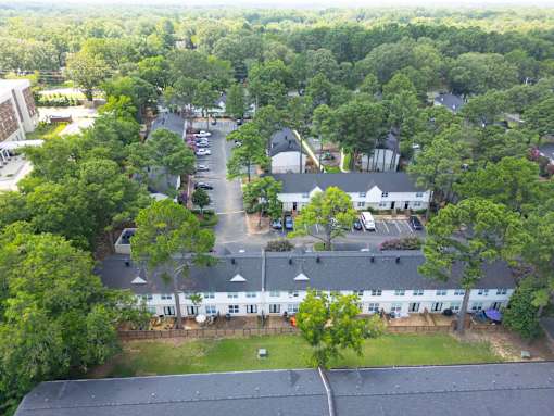 Bird's eye view of a residential area with houses and trees at The Garden District Apartments, Germantown