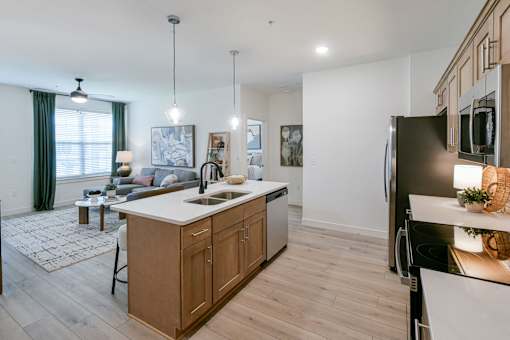 A modern kitchen with wooden cabinets and a large island. at Grays Creek Apartments, Cordova, TN, 38018