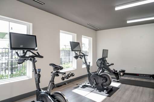 A room with exercise equipment and a TV at Harbor Side at Conwood Flats Apartments in Uptown Memphis, TN