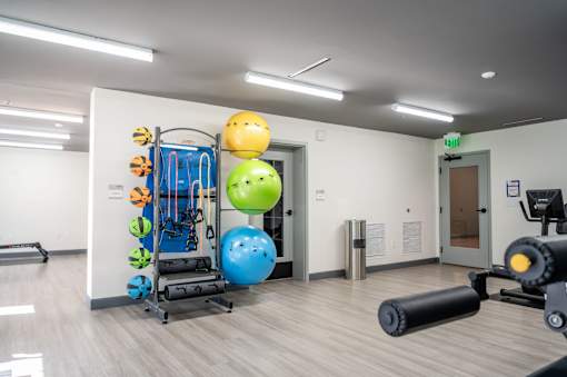A gym with a variety of equipment including a treadmill, a stationary bike, and a rowing machine at Harbor Side at Conwood Flats Apartments, Memphis, Tennessee
