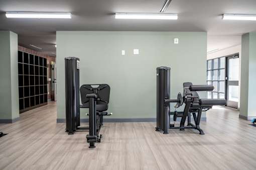 A gym with two exercise machines and a window at Harbor Side at Conwood Flats Apartments, Memphis