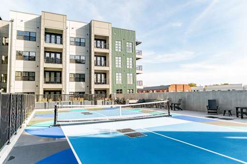 A swimming pool on a rooftop surrounded by chairs and buildings at Harbor Side at Conwood Flats Apartments, Memphis