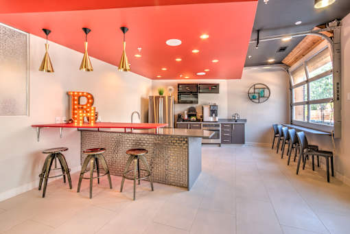 A bar area with a counter and stools at Highland Row Apartments, Memphis, Tennessee