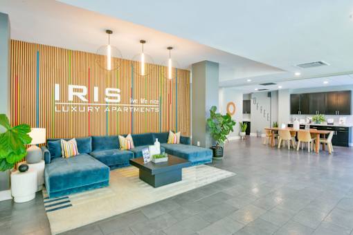 A living room with a blue couch and a sign that says "LIS".
