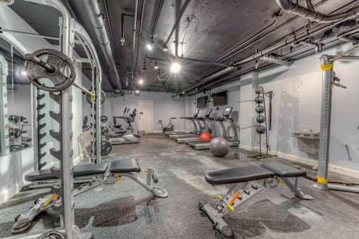 A gym with a variety of equipment including weights and benches.at Iris Luxury Apartments, Memphis Tennessee  